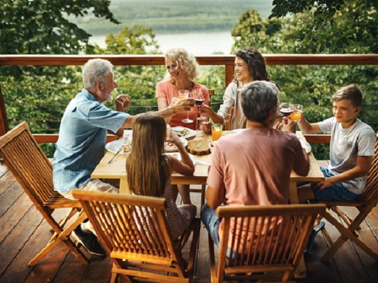 Family having dinner party outside on the deck