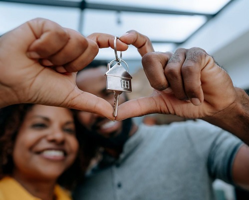 Couple holding keys to their new house